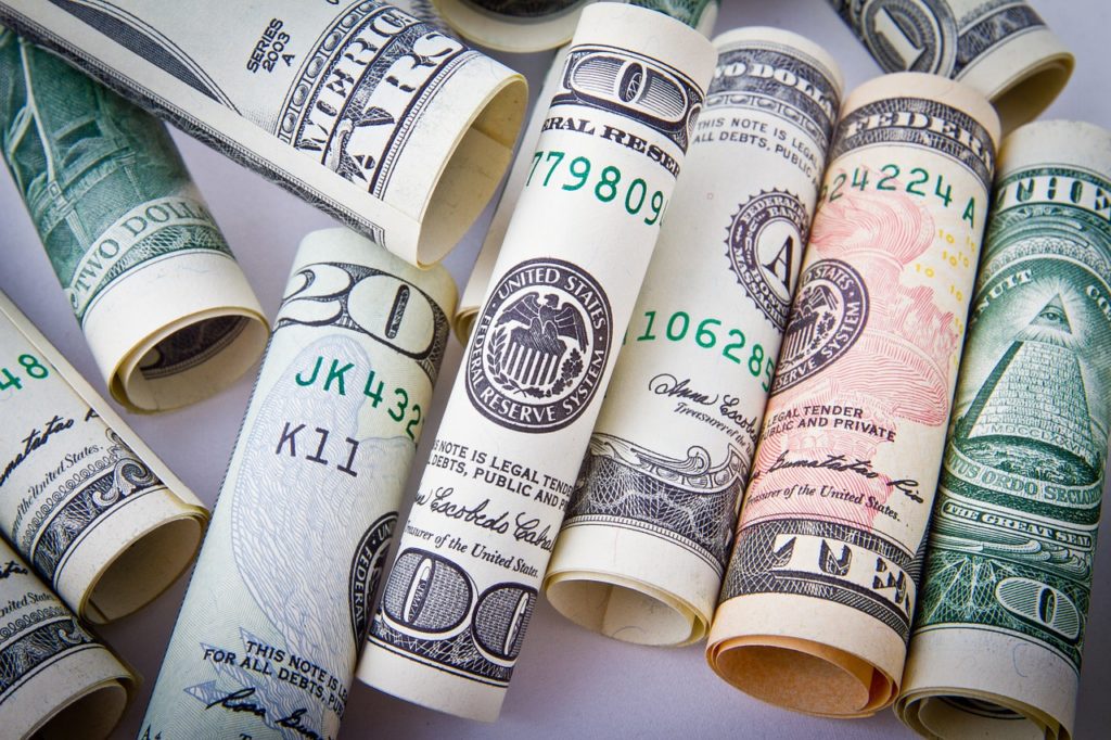 Dollar slides as rate hike prospects ease, oil gains moderate